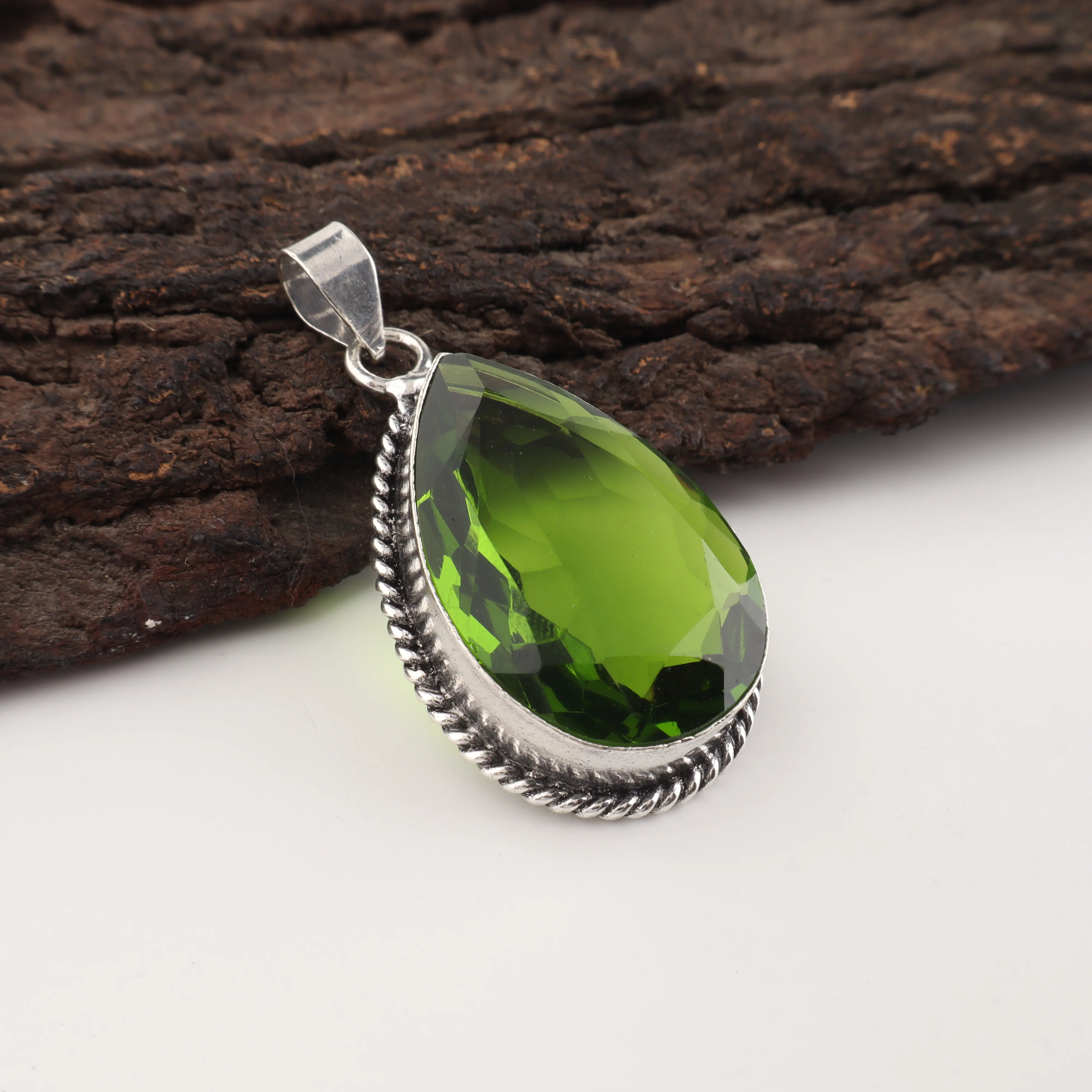 Handmade green peridot pendant in sterling silver, August birthstone gemstone necklace close-up