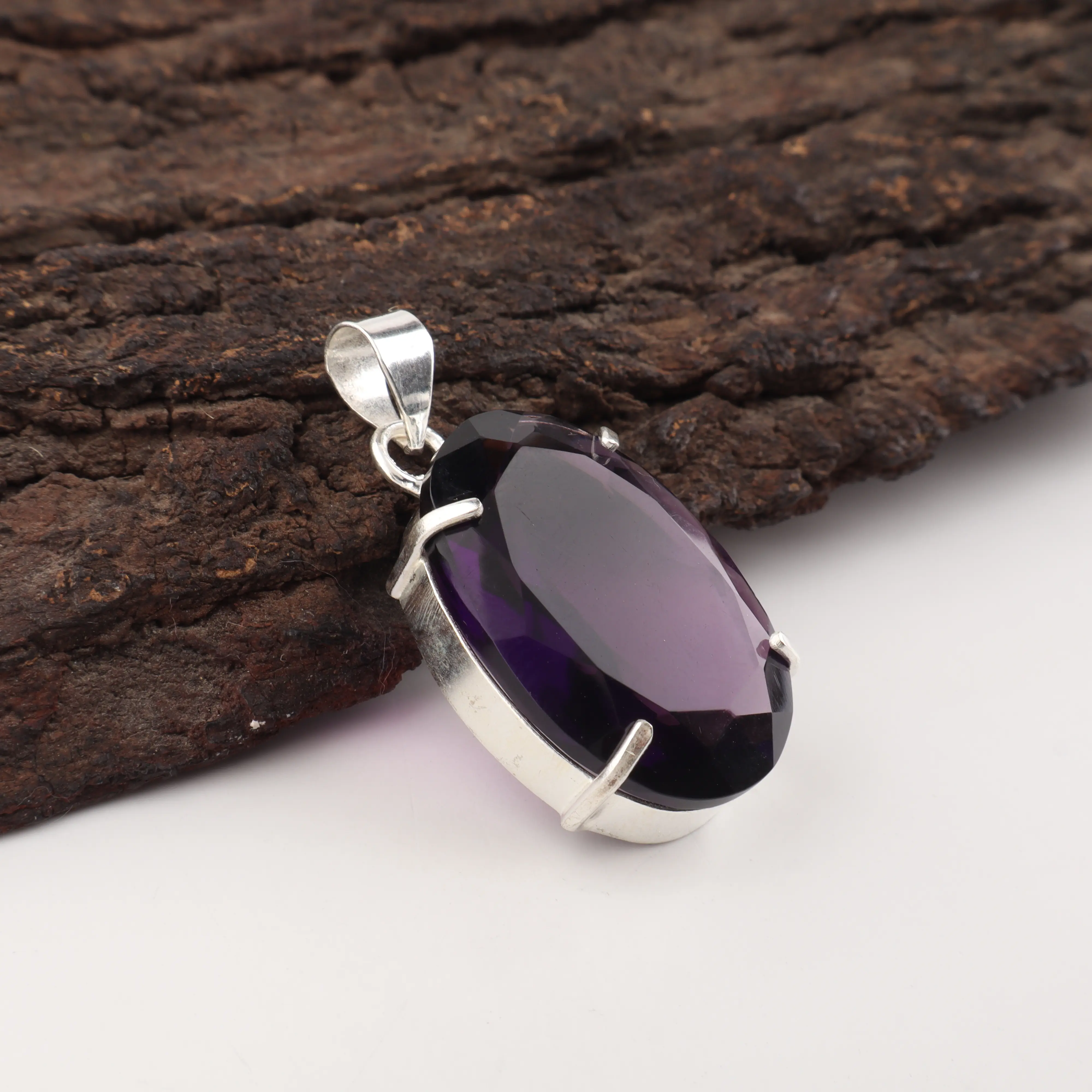 purple amethyst pendant with polished gemstone in elegant jewelry setting