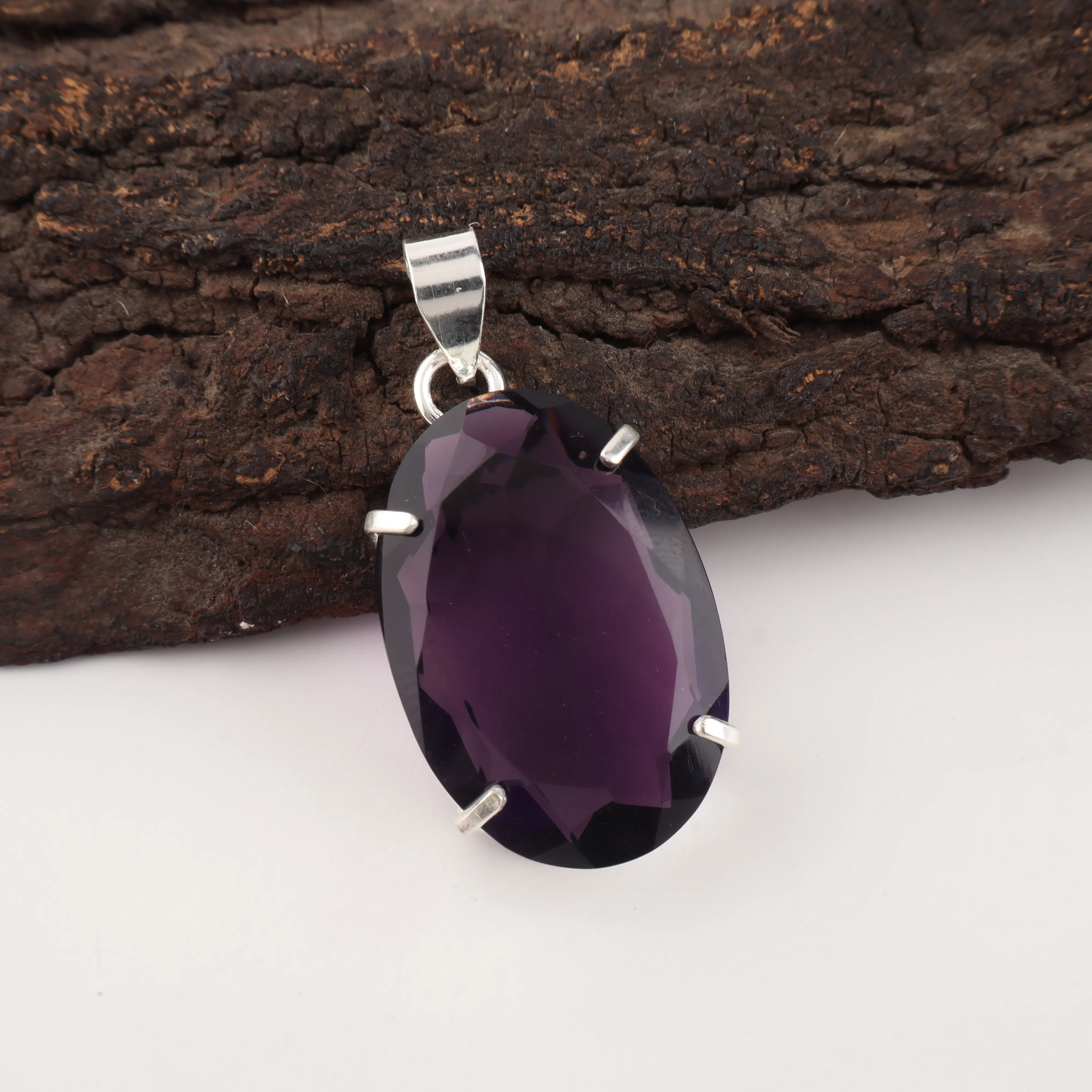 purple amethyst pendant with polished gemstone in elegant jewelry setting