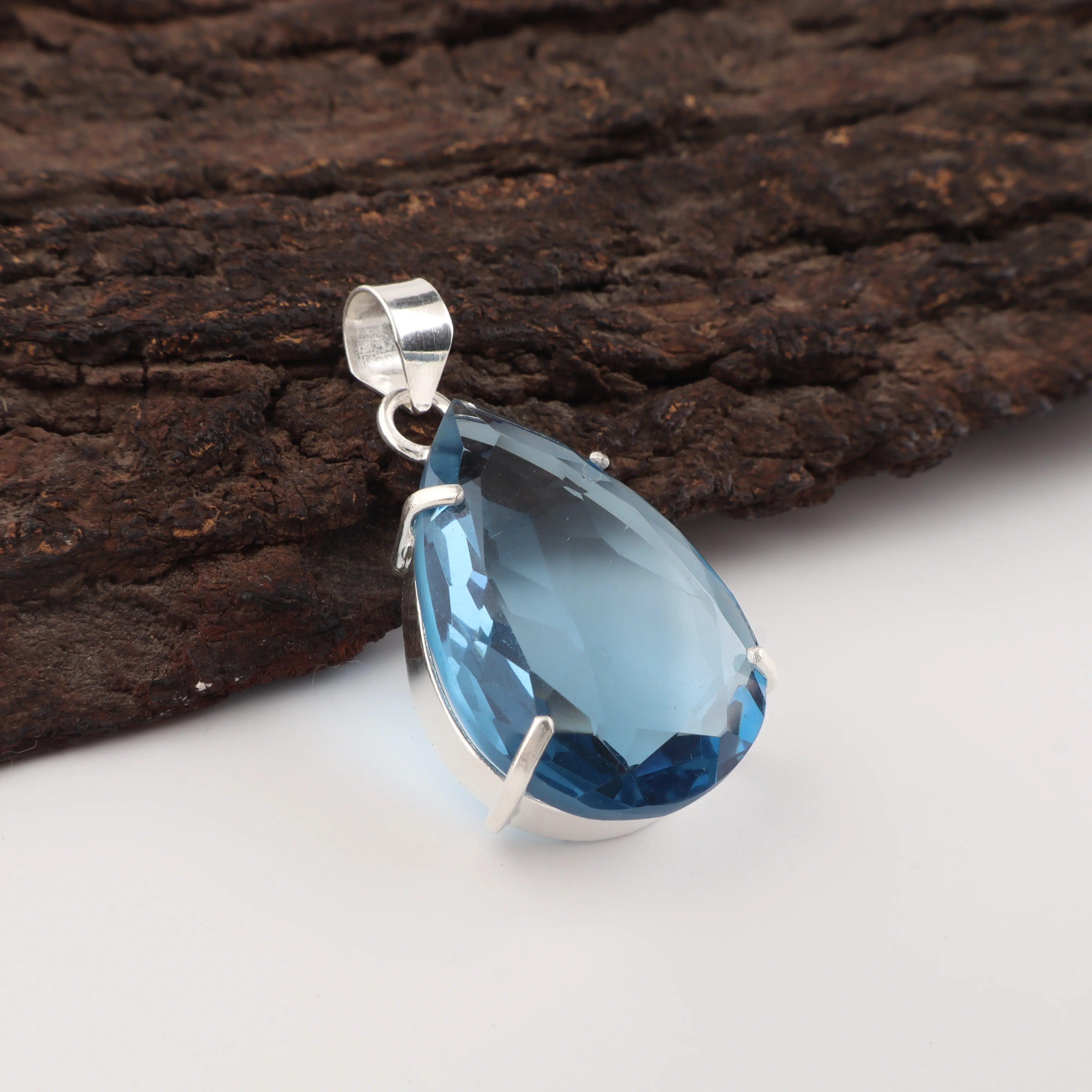 London Blue Topaz gemstone pendant with deep blue color in a handcrafted jewelry setting.