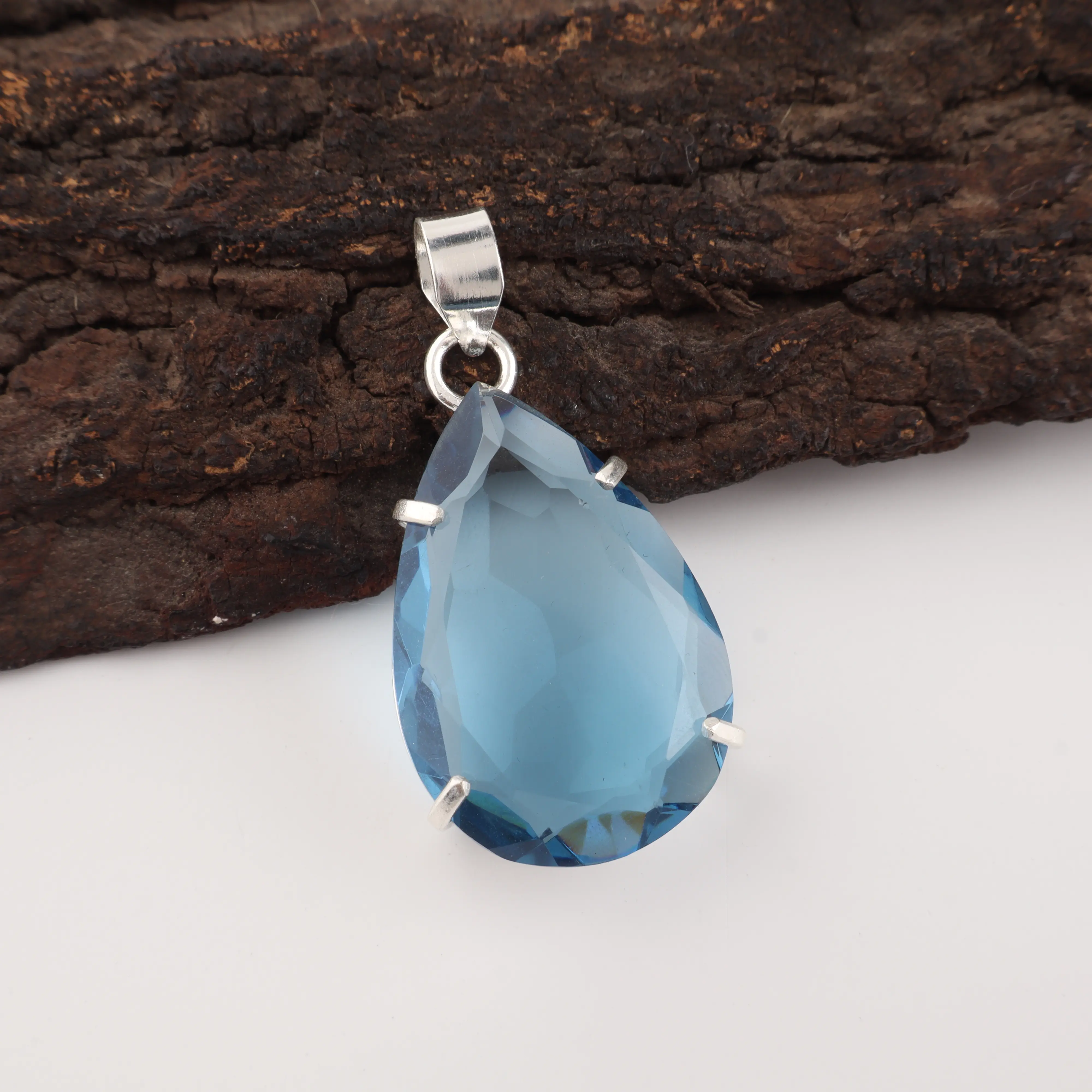 London Blue Topaz gemstone pendant with deep blue color in a handcrafted jewelry setting.