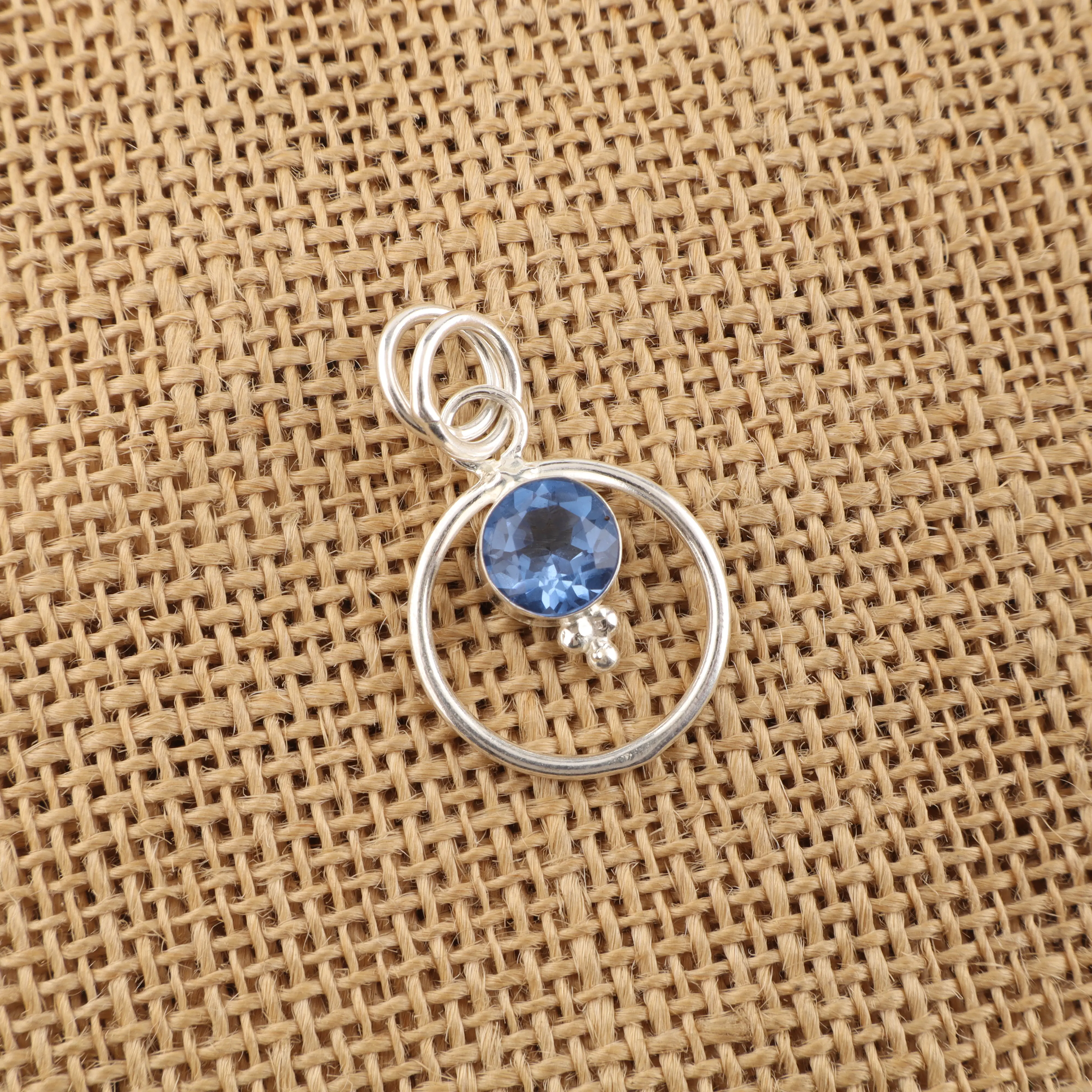 Tanzanite gemstone pendant with vibrant violet-blue color in a handmade jewelry design.