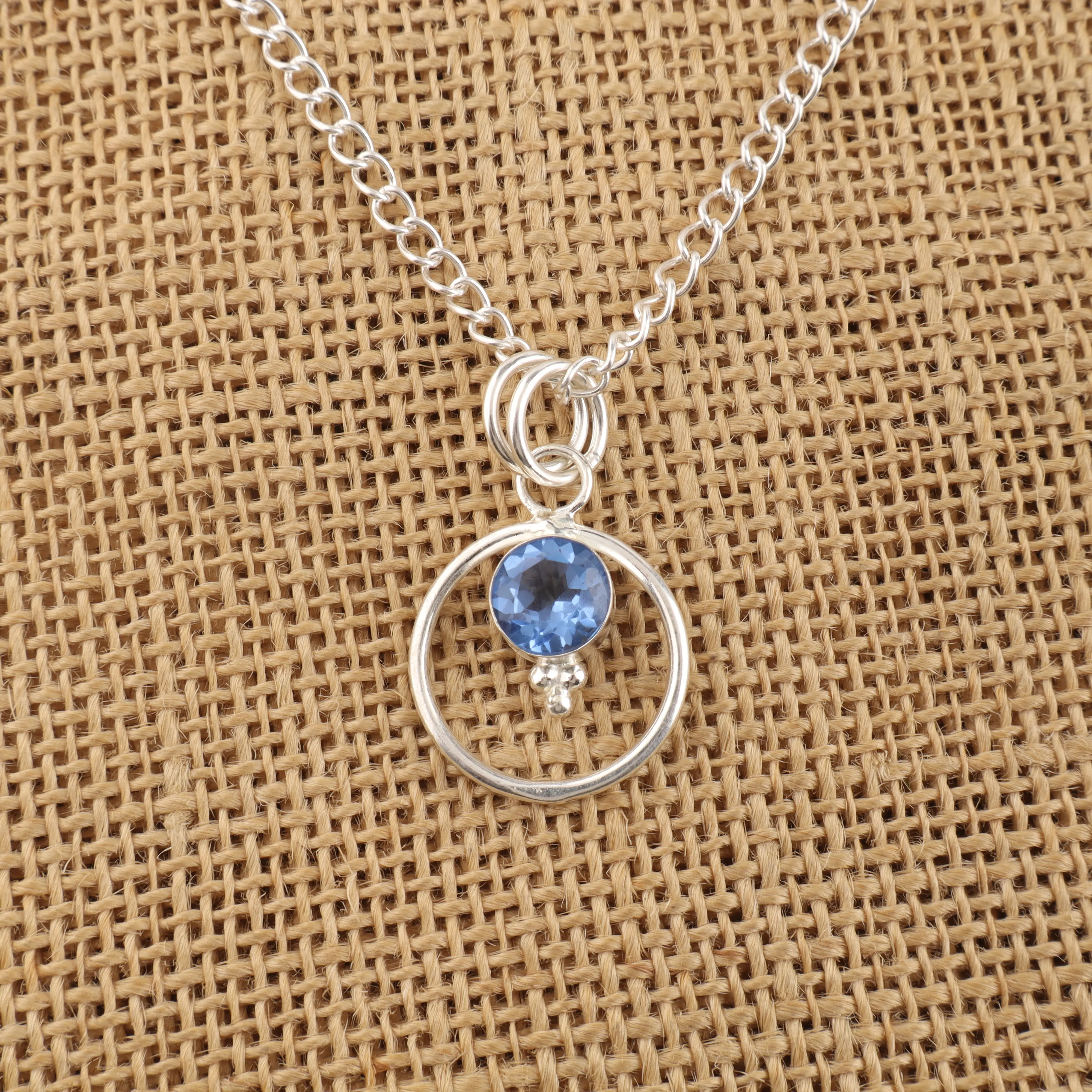 Tanzanite gemstone pendant with vibrant violet-blue color in a handmade jewelry design.