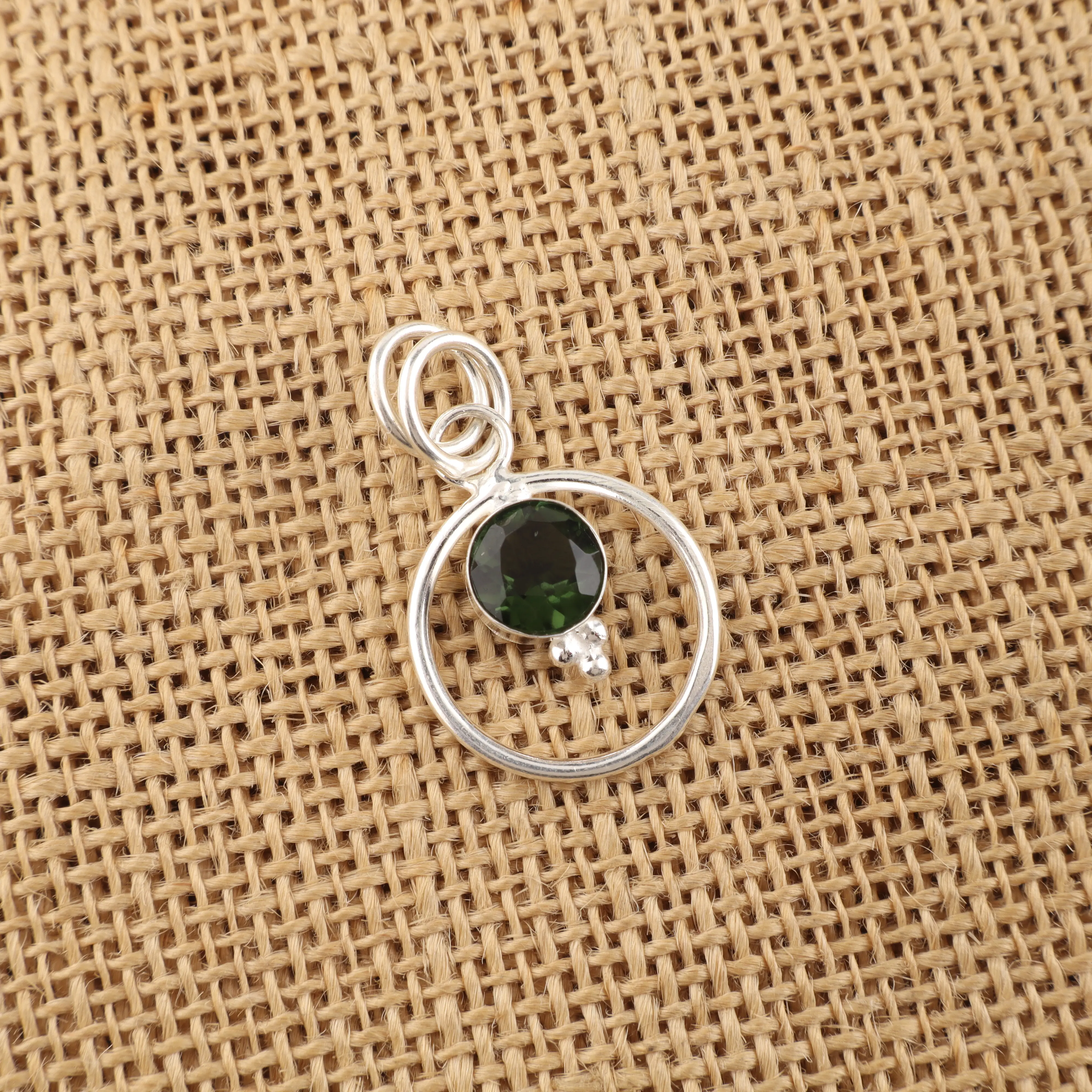 Green tourmaline pendant with polished gemstone in elegant handcrafted setting