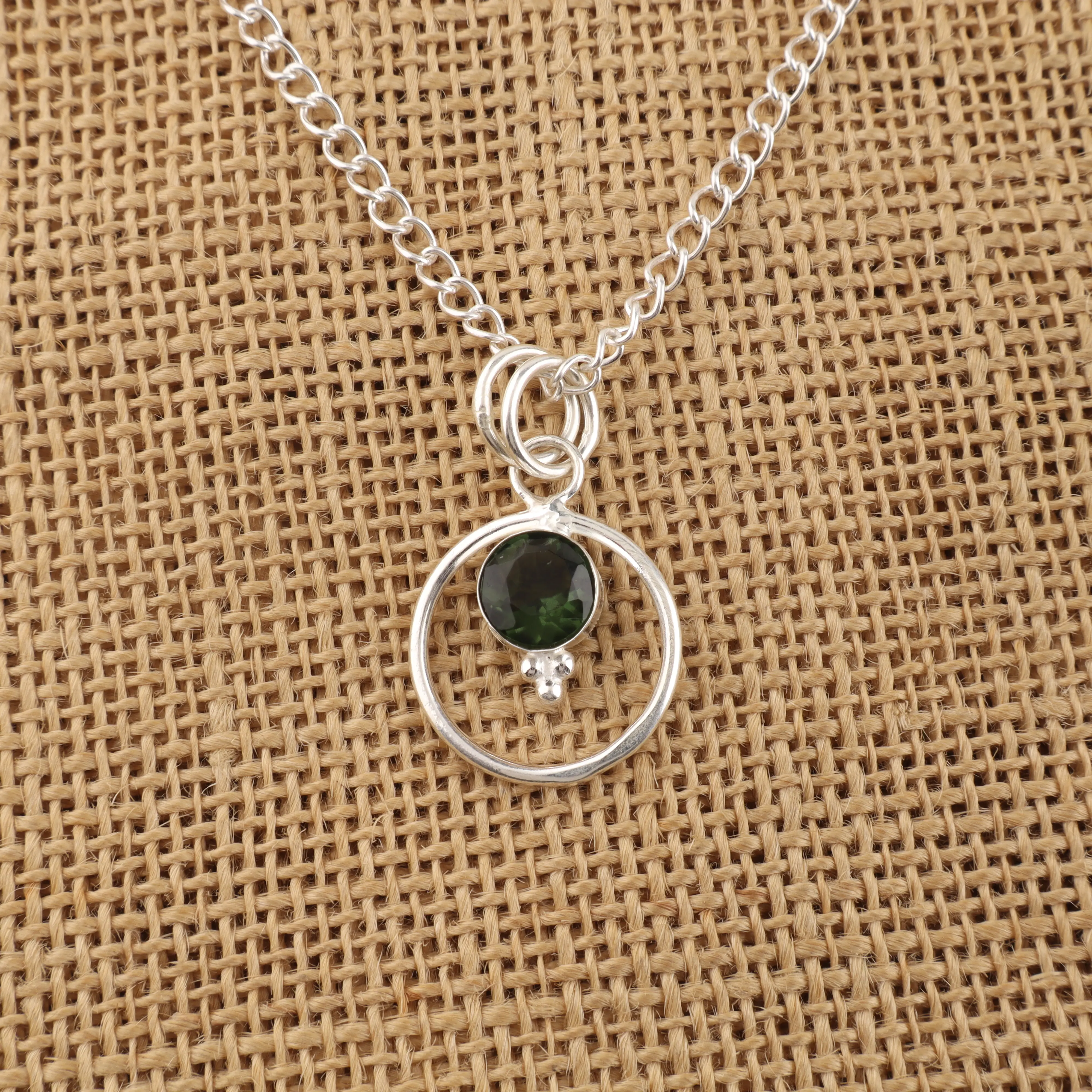 Green tourmaline pendant with polished gemstone in elegant handcrafted setting