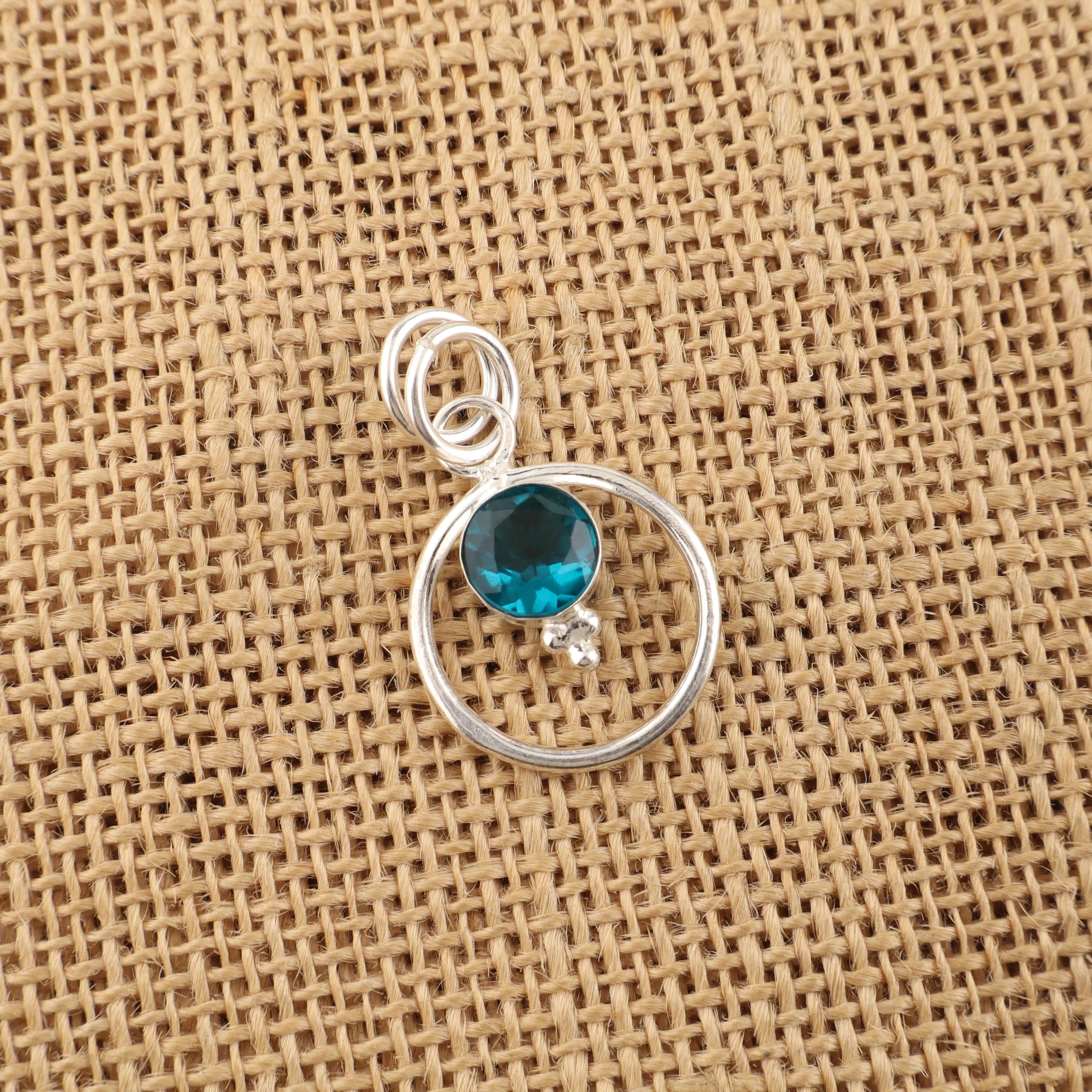 Blue apatite gemstone pendant with vibrant ocean blue color in handcrafted jewelry design