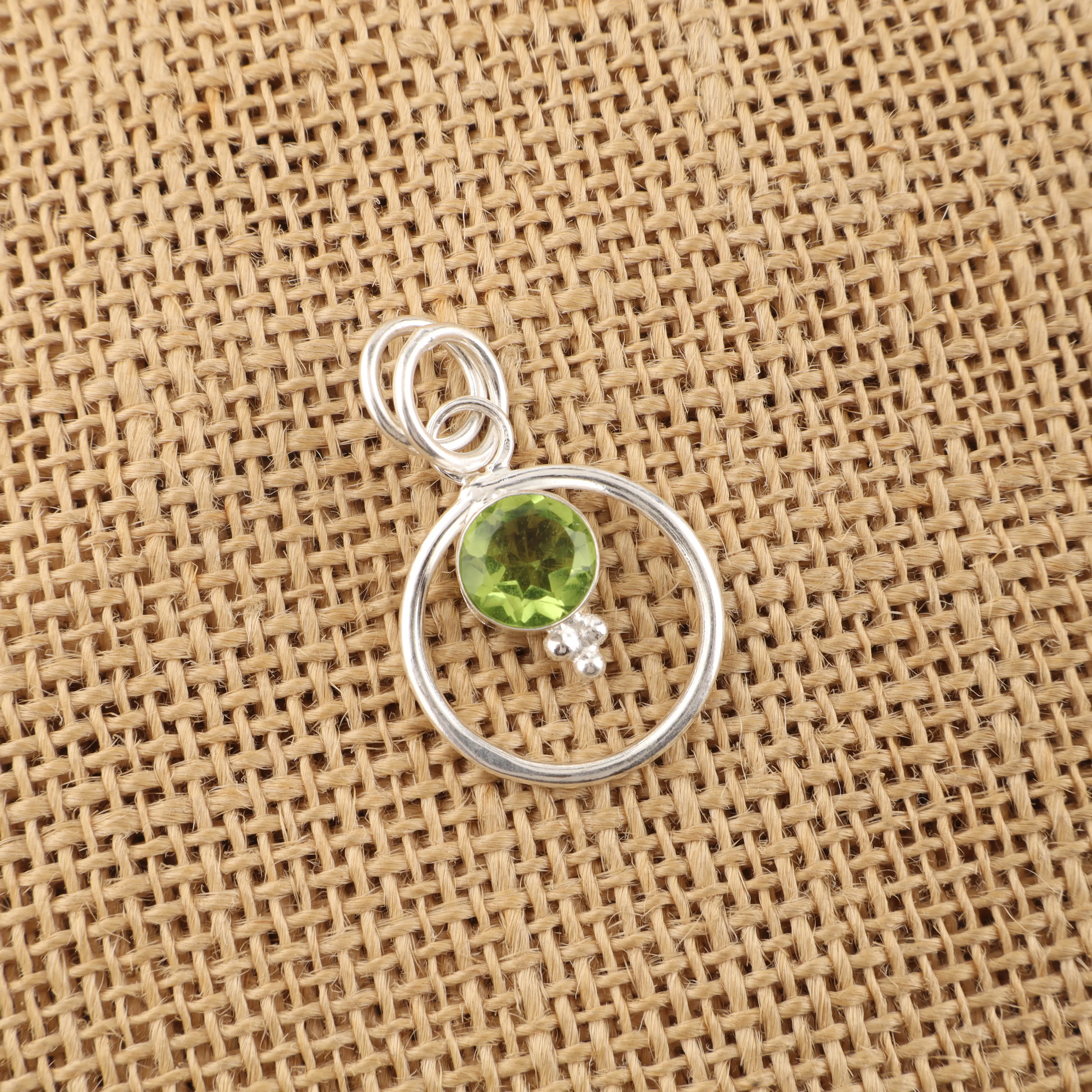 Peridot pendant with vibrant green gemstone in a handcrafted jewelry setting