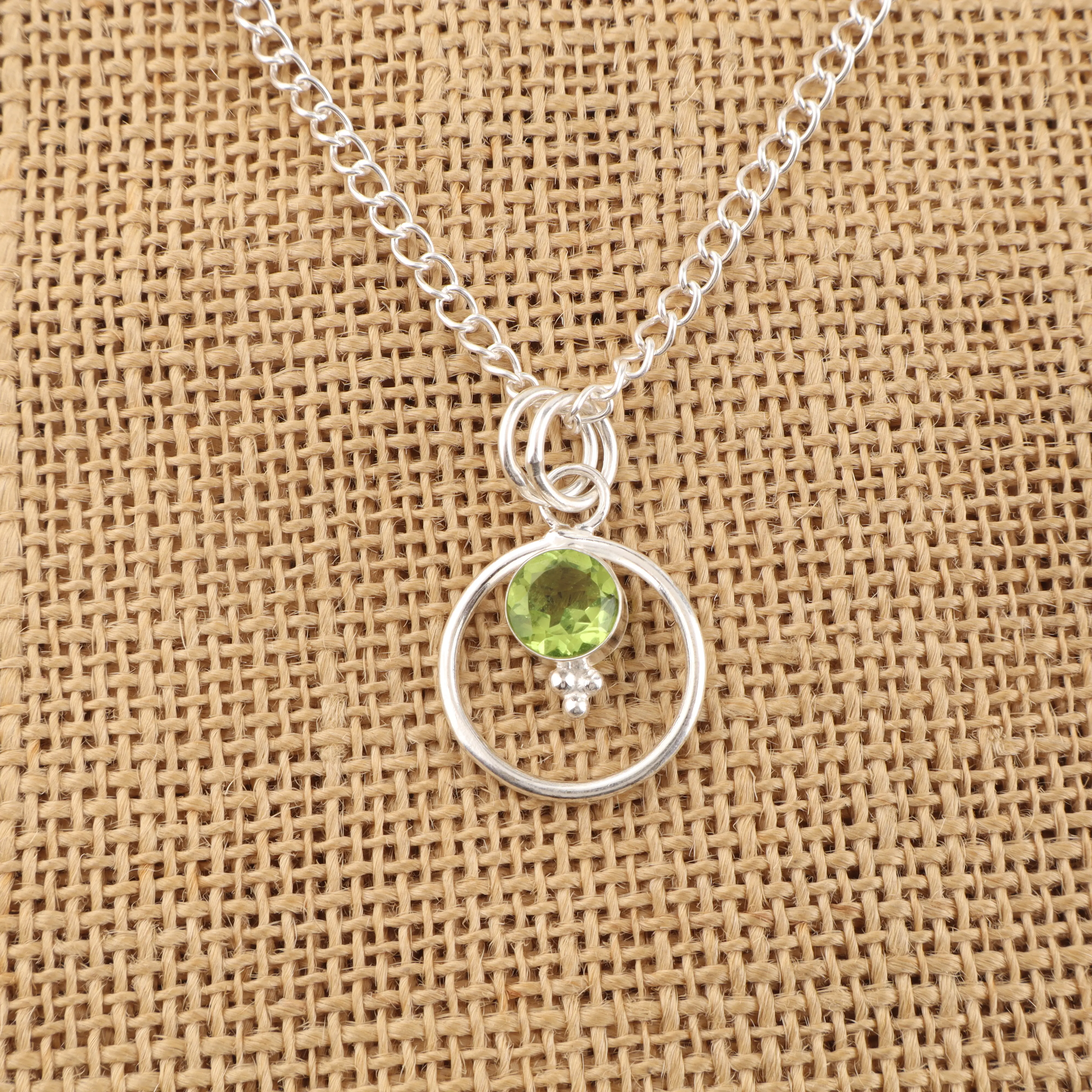 Peridot pendant with vibrant green gemstone in a handcrafted jewelry setting