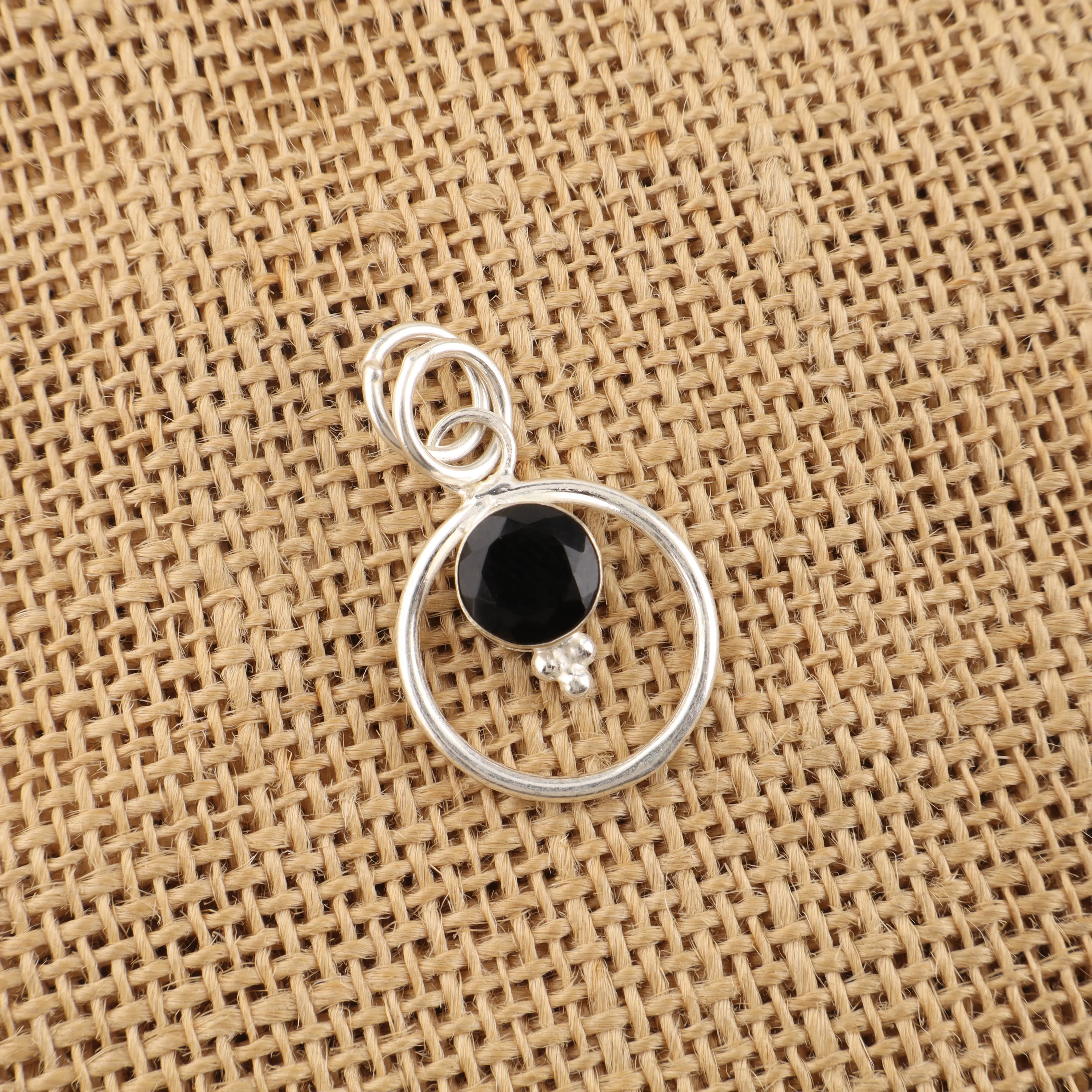 Black onyx pendant necklace with polished black gemstone in elegant minimalist setting