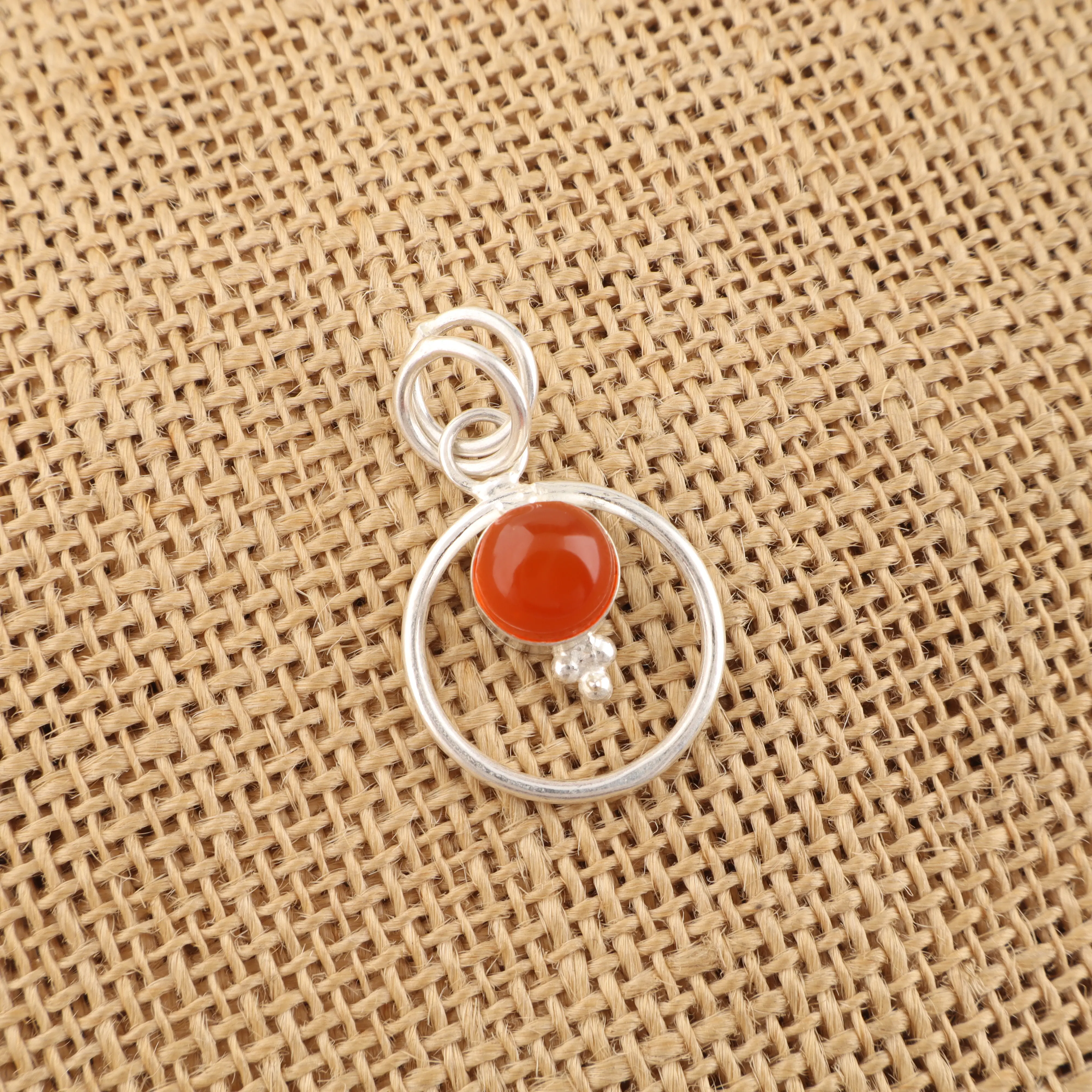 Carnelian pendant in sterling silver with vibrant orange-red gemstone