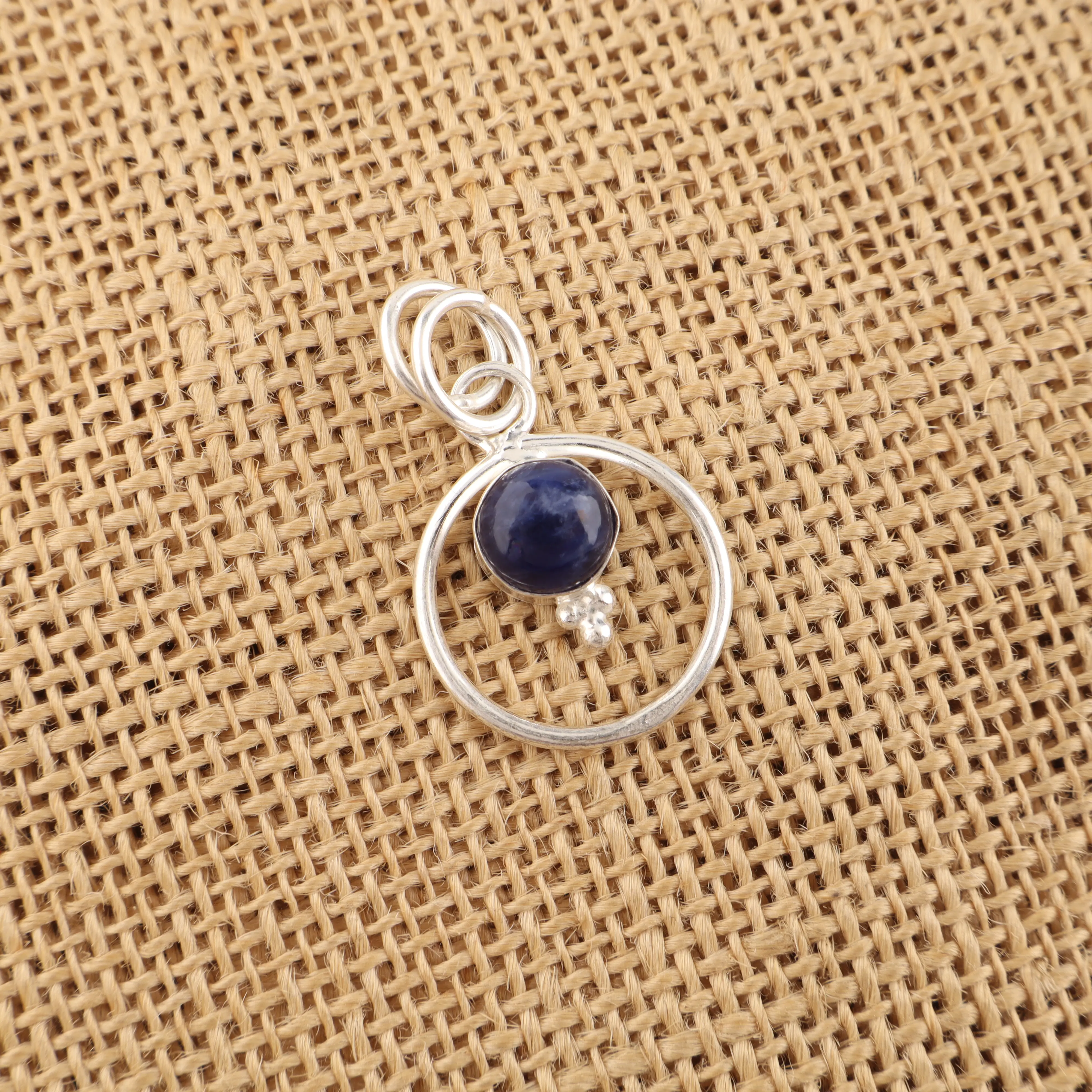 Sodalite pendant with deep blue stone and white veining in handmade jewelry setting