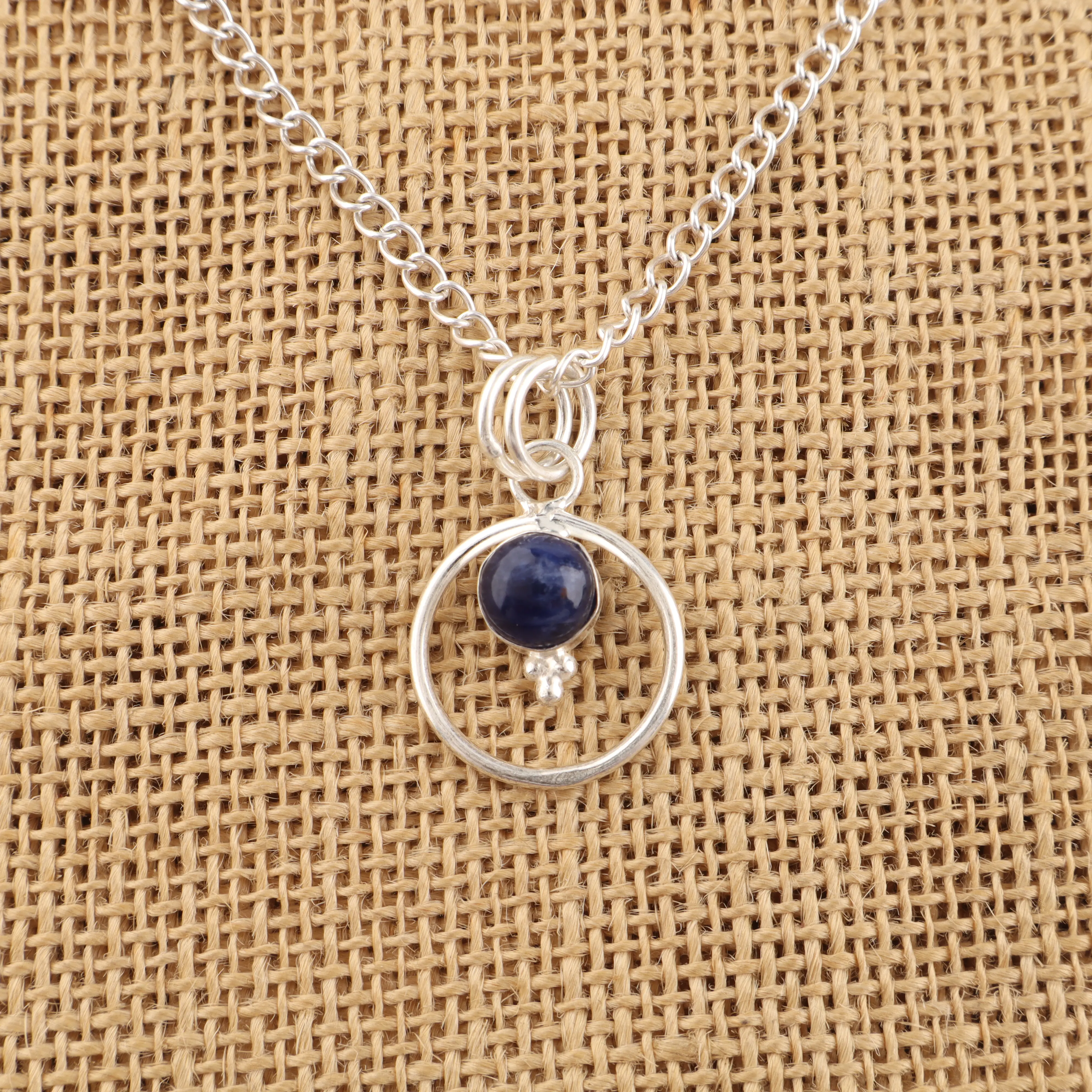Sodalite pendant with deep blue stone and white veining in handmade jewelry setting