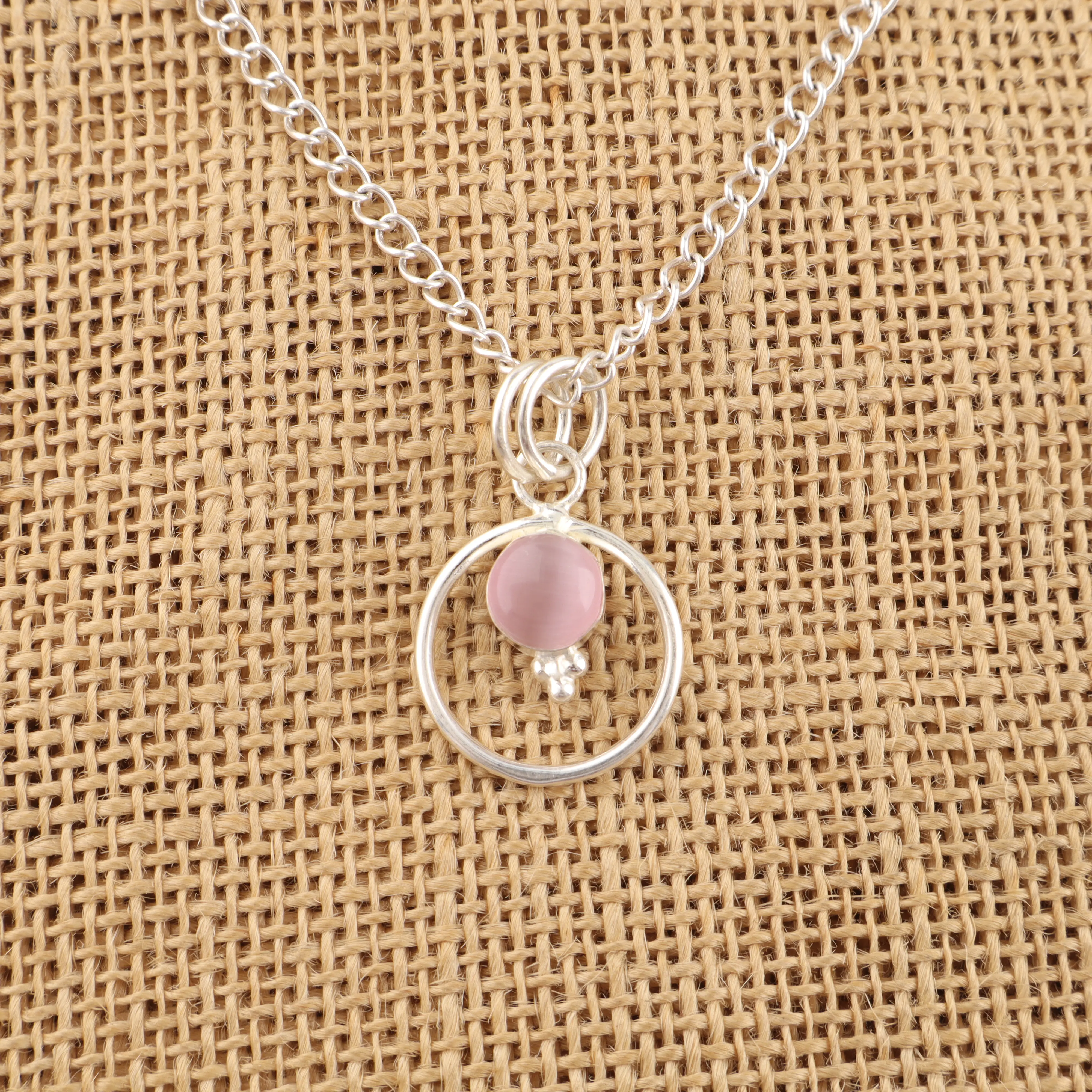 Handmade Pink Cat's Eye Pendant in 925 sterling silver featuring a polished pink gemstone with a luminous cat's eye effect.