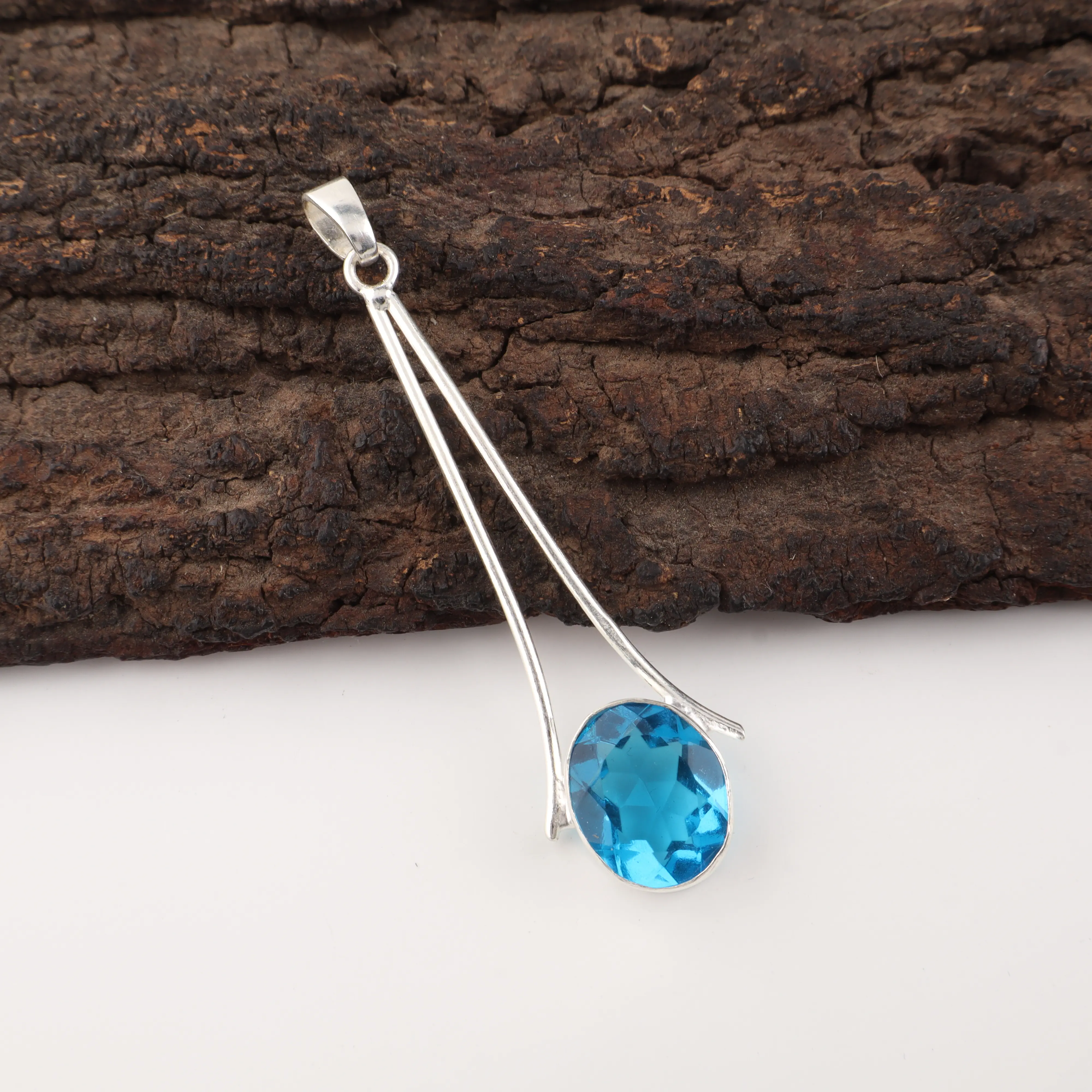 Handcrafted Swiss Blue Topaz pendant in 925 sterling silver featuring a vibrant blue gemstone necklace.