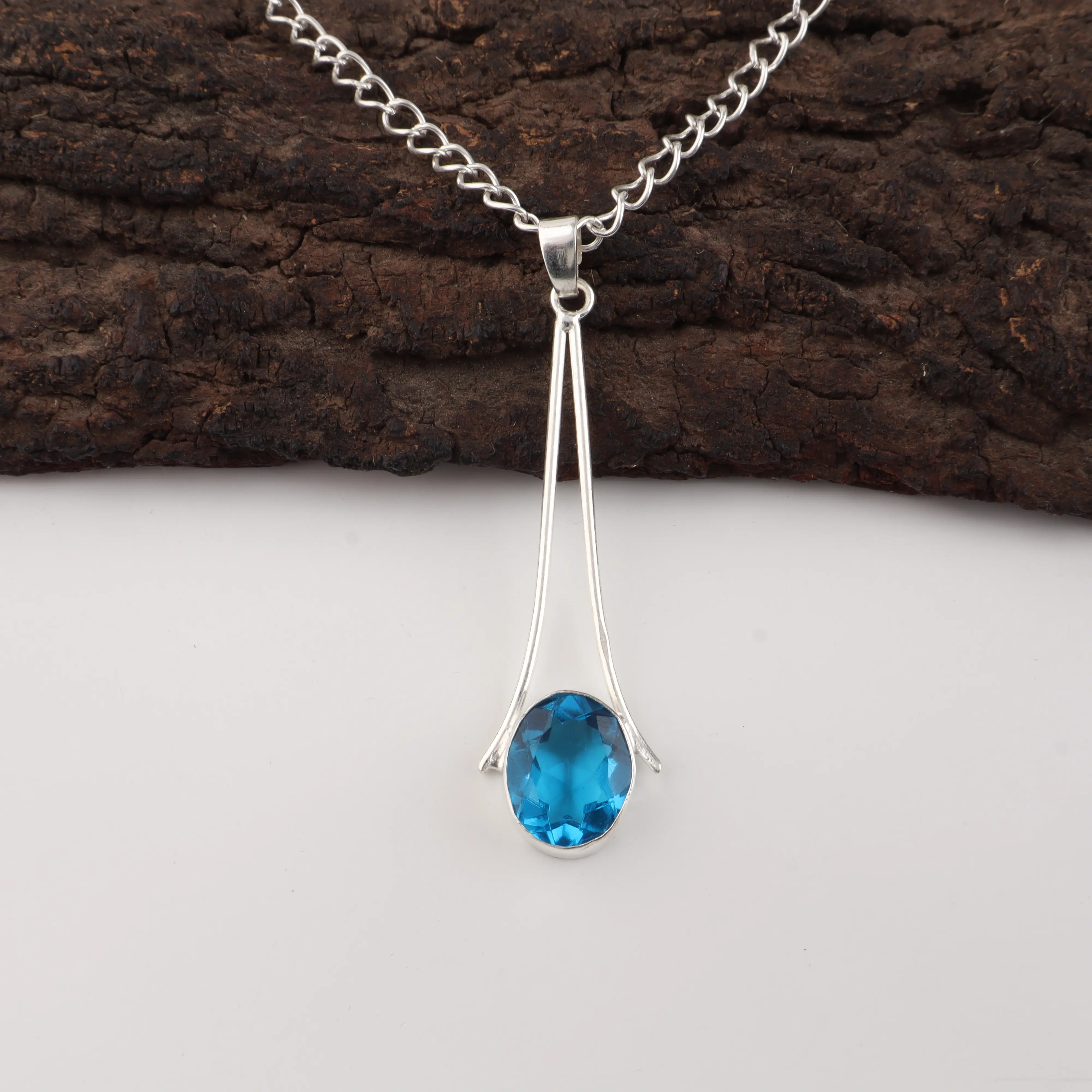 Handcrafted Swiss Blue Topaz pendant in 925 sterling silver featuring a vibrant blue gemstone necklace.