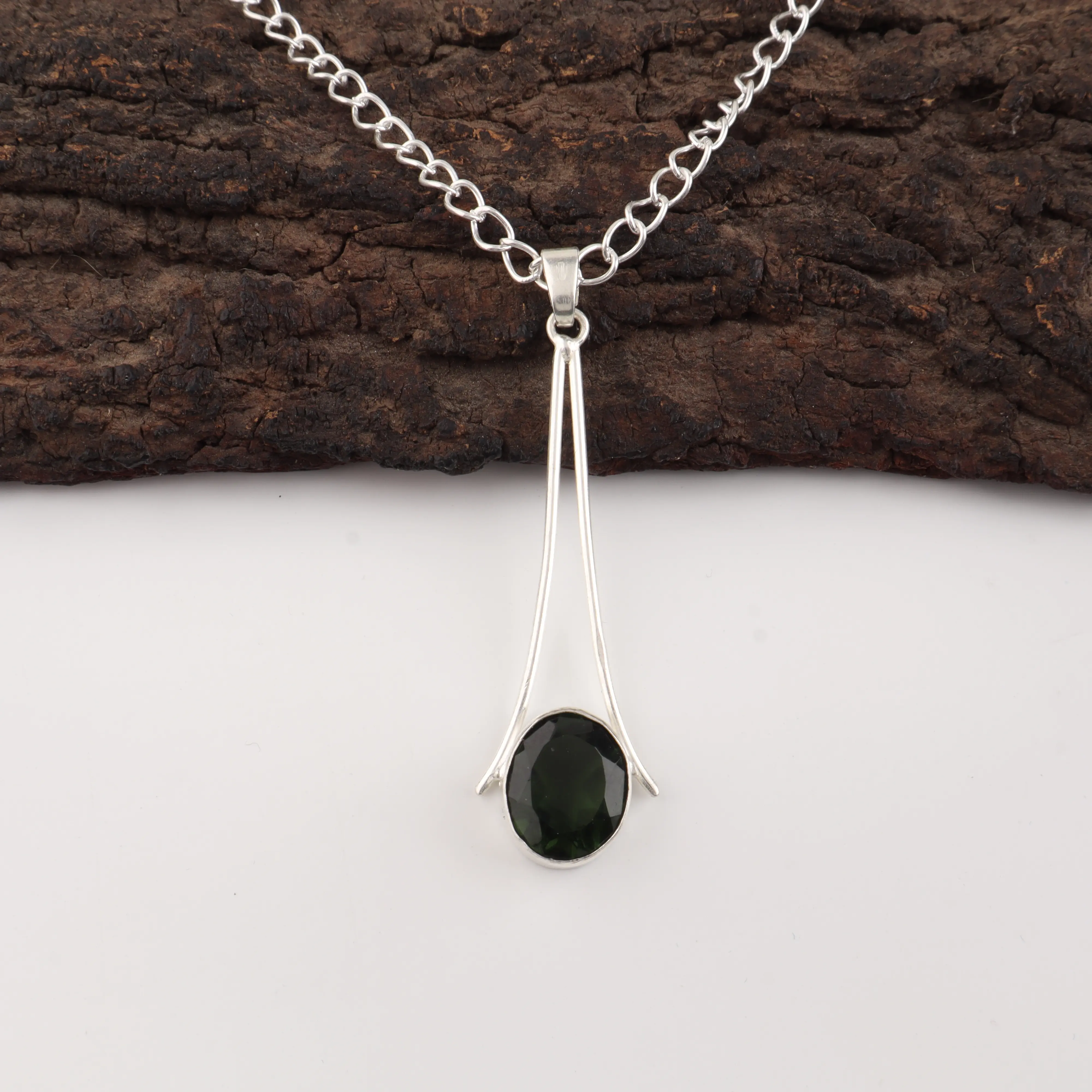 Green tourmaline pendant necklace with polished gemstone in handmade setting