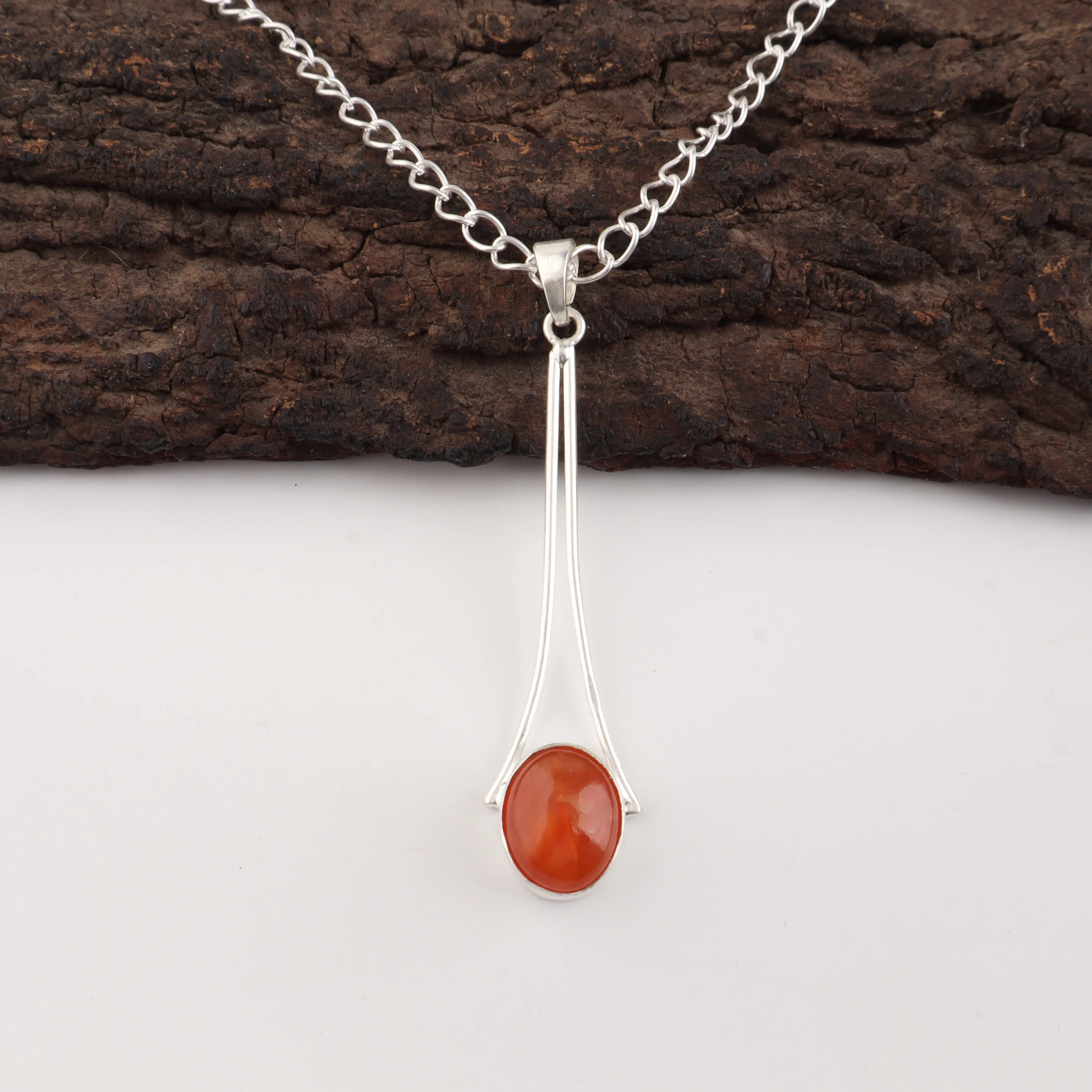 Handmade Carnelian pendant featuring a natural orange gemstone set in polished 925 sterling silver.