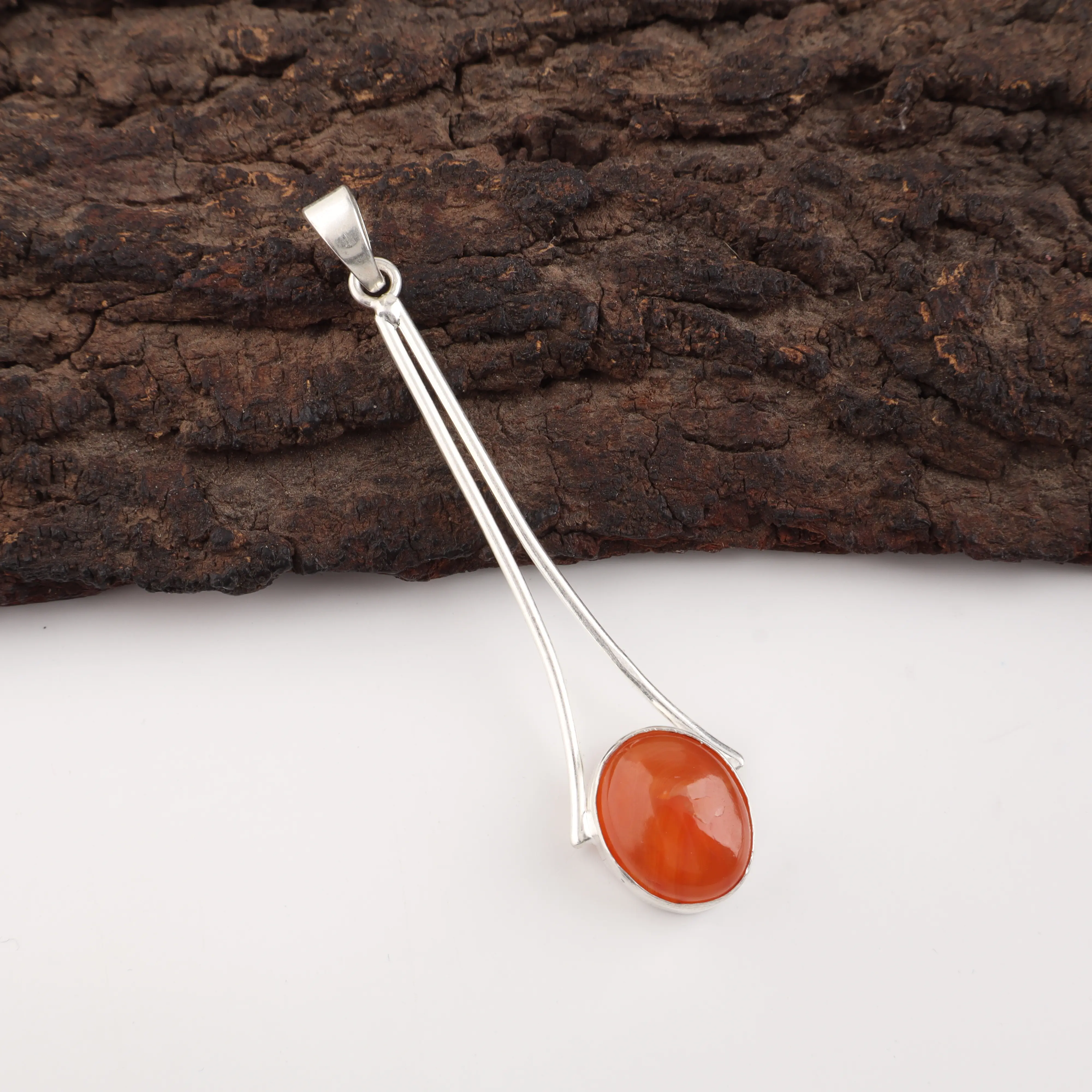Handmade Carnelian pendant featuring a natural orange gemstone set in polished 925 sterling silver.