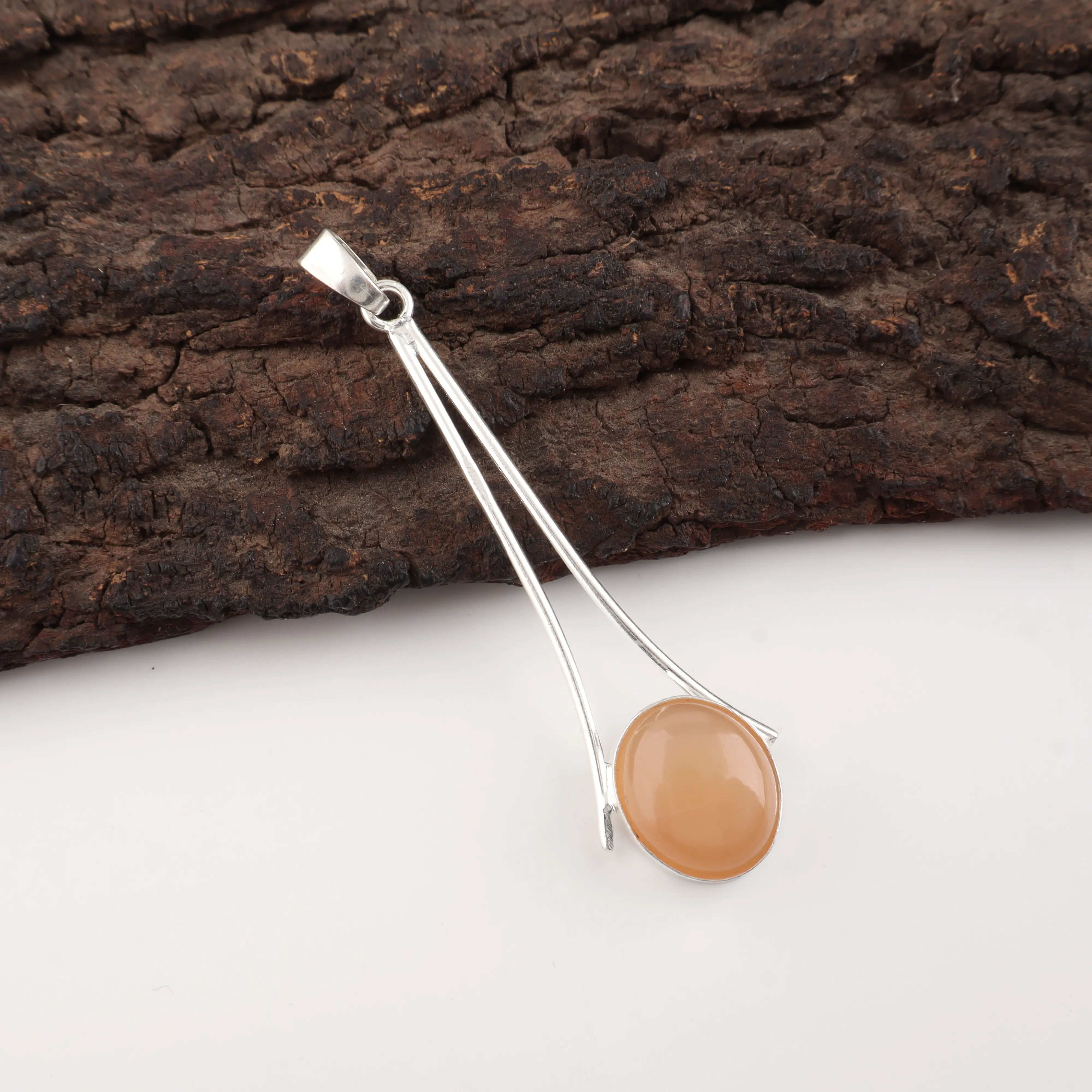 Natural Peach Moonstone pendant handcrafted in polished 925 sterling silver with a glowing peach gemstone centerpiece.